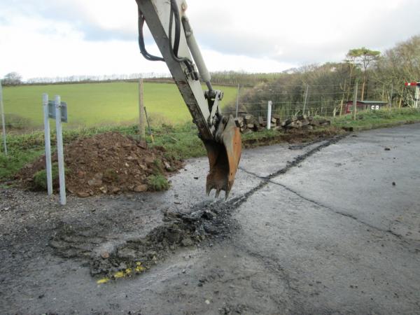 The excavator begins breaking up the tarmac, 9th January 2014